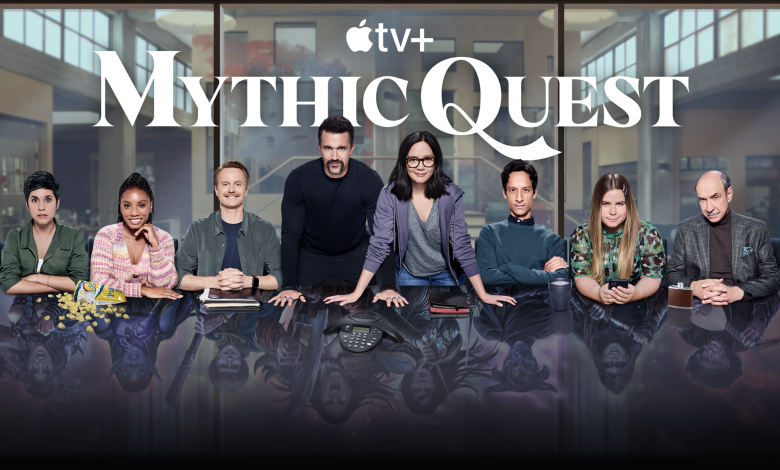 The cast of Mythic Quest behind a conference table.