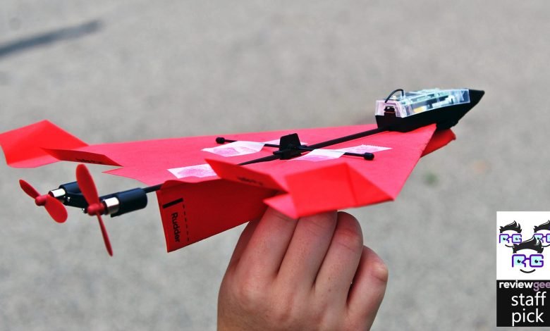 A paper airplane connected to an RC drone